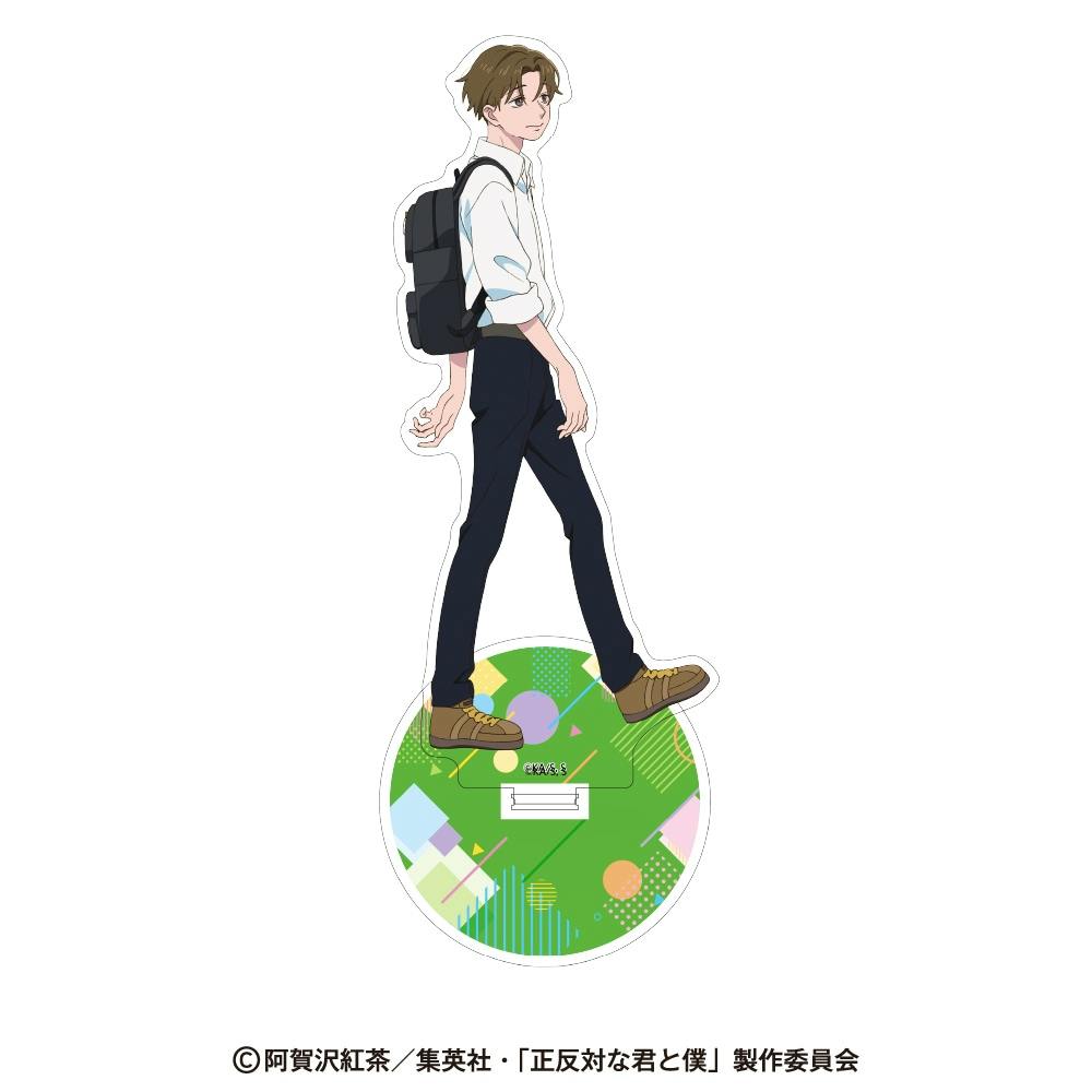 Front view of the acrylic stand showing an illustrated male character wearing a backpack standing on a green patterned round base against a white background.