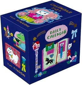 Photo of the Yumi Kitakishi NK4500 Mini Mini Daily Calendar cube box showing colorful illustrated panels and the 'Daily Calendar' label.