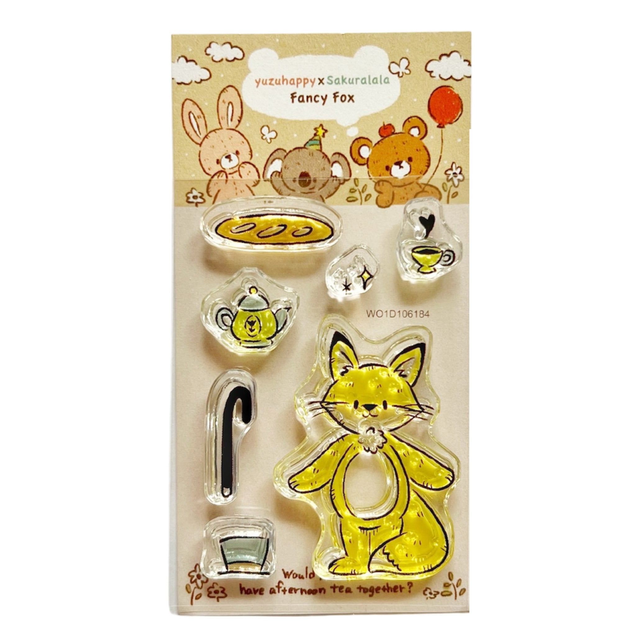 Packaged set of clear plastic stamps showing a yellow fox and tea-themed designs.