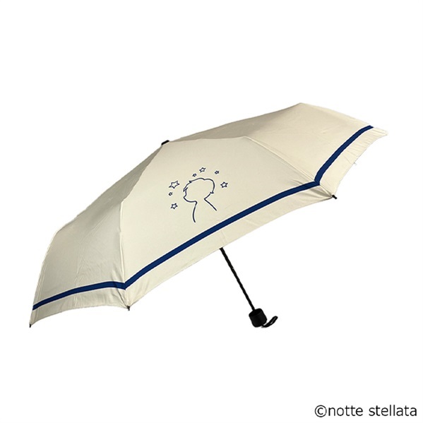 Cream-colored folding umbrella with a blue border and a silhouetted head with stars printed on the canopy, shown open on a white background.