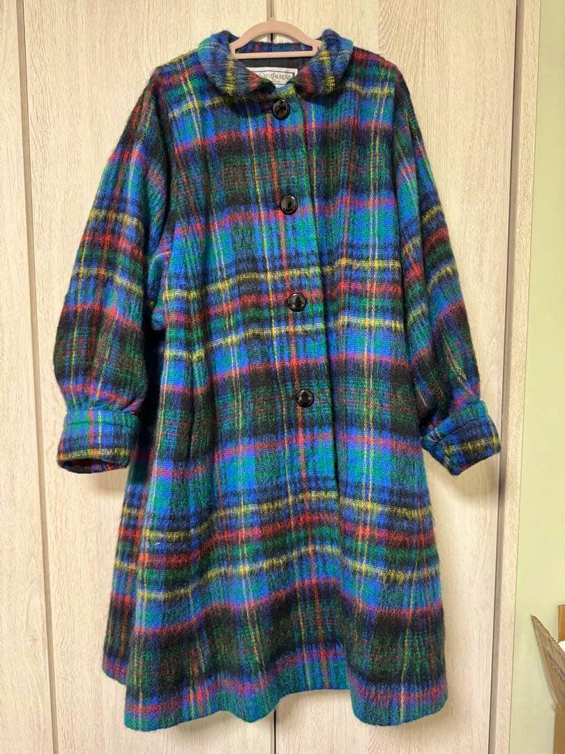 Front view of the Yves Saint Laurent check-pattern shaggy long wool women's coat hanging on a wooden hanger.