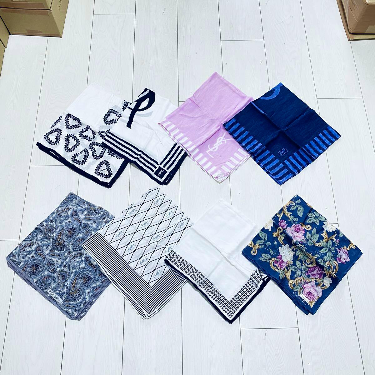 Eight folded women's handkerchiefs in different patterns arranged on a light wooden floor.