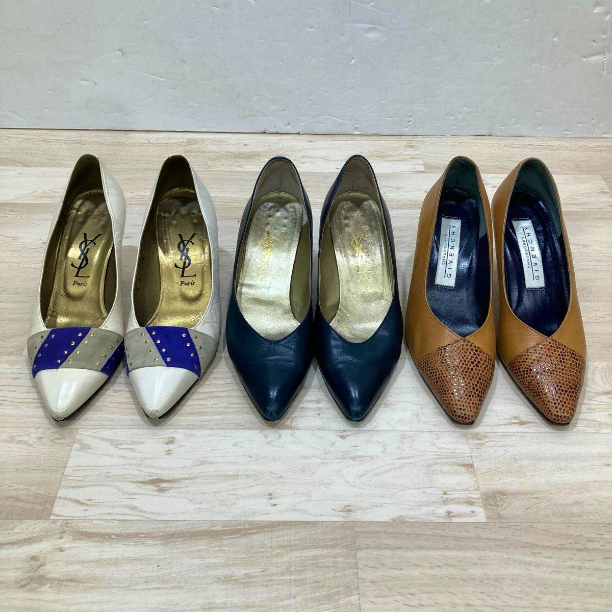 Three pairs of women's leather heeled pumps (Yves Saint Laurent and Givenchy) shown front-facing on a light wooden floor.