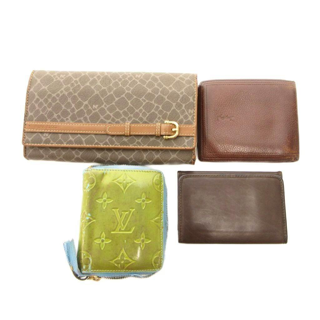 Four leather wallets and a green zip coin purse displayed together on a white background.