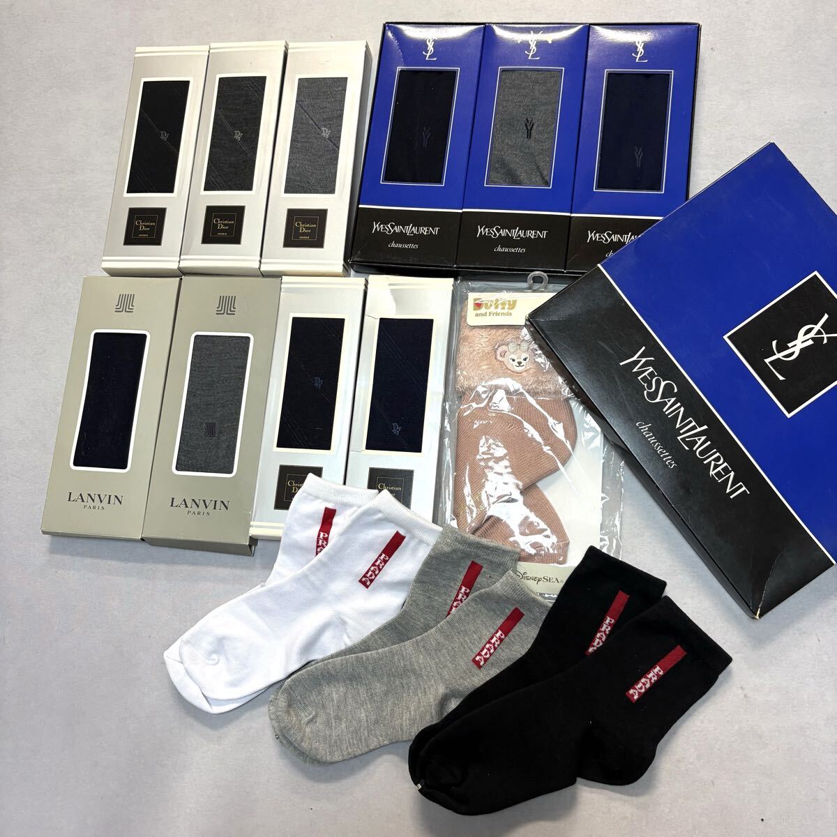 Group photo of multiple boxed and loose branded socks arranged on a flat surface.