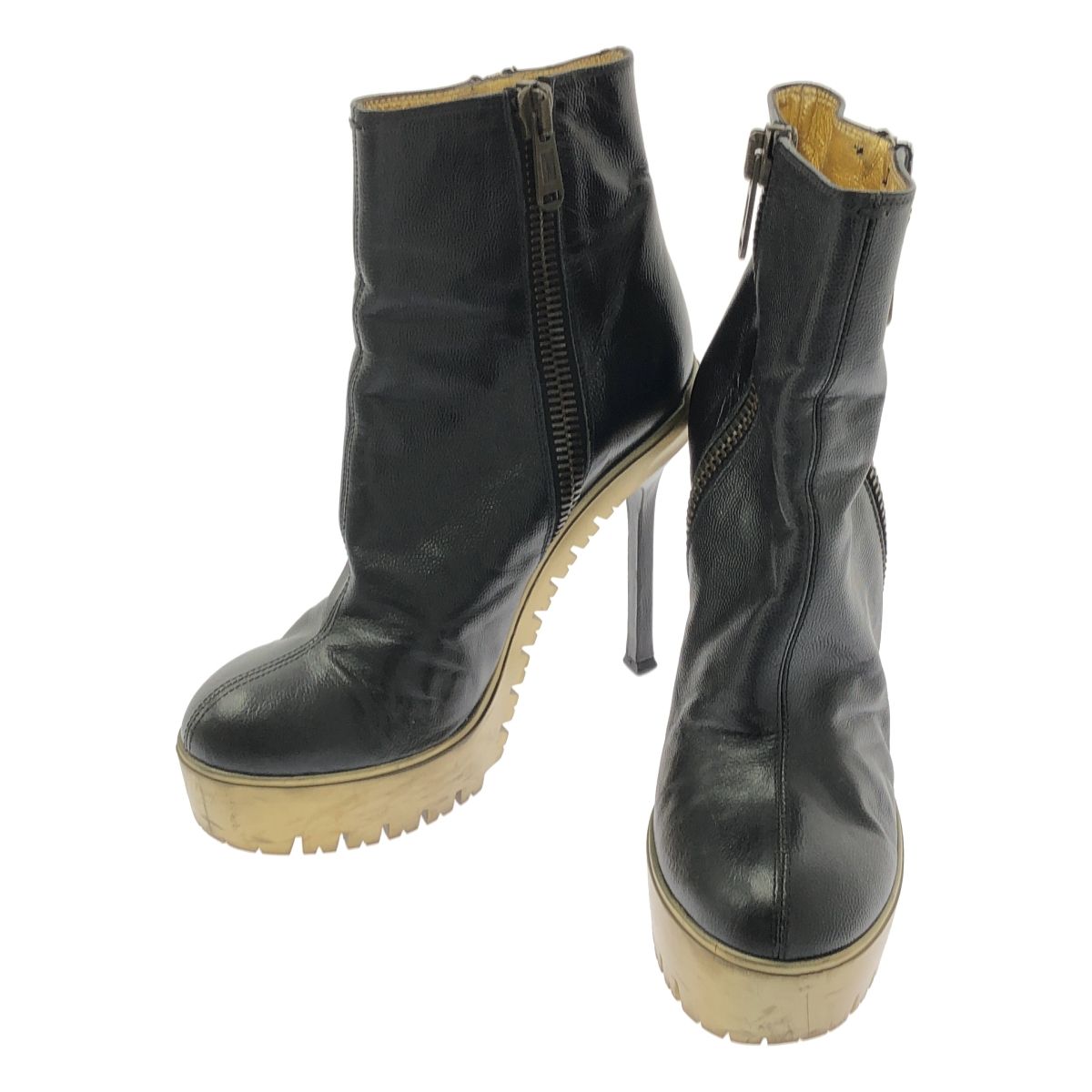Black Yves Saint Laurent leather side-zip short boots with gold-toned platform and stiletto heels, shown as a pair.