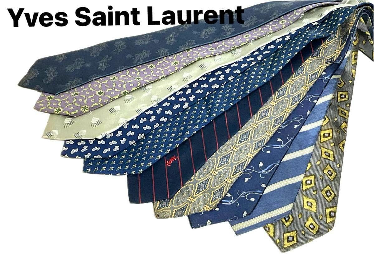 Ten Yves Saint Laurent silk neckties with assorted patterns fanned out on a white background with 'Yves Saint Laurent' text above.