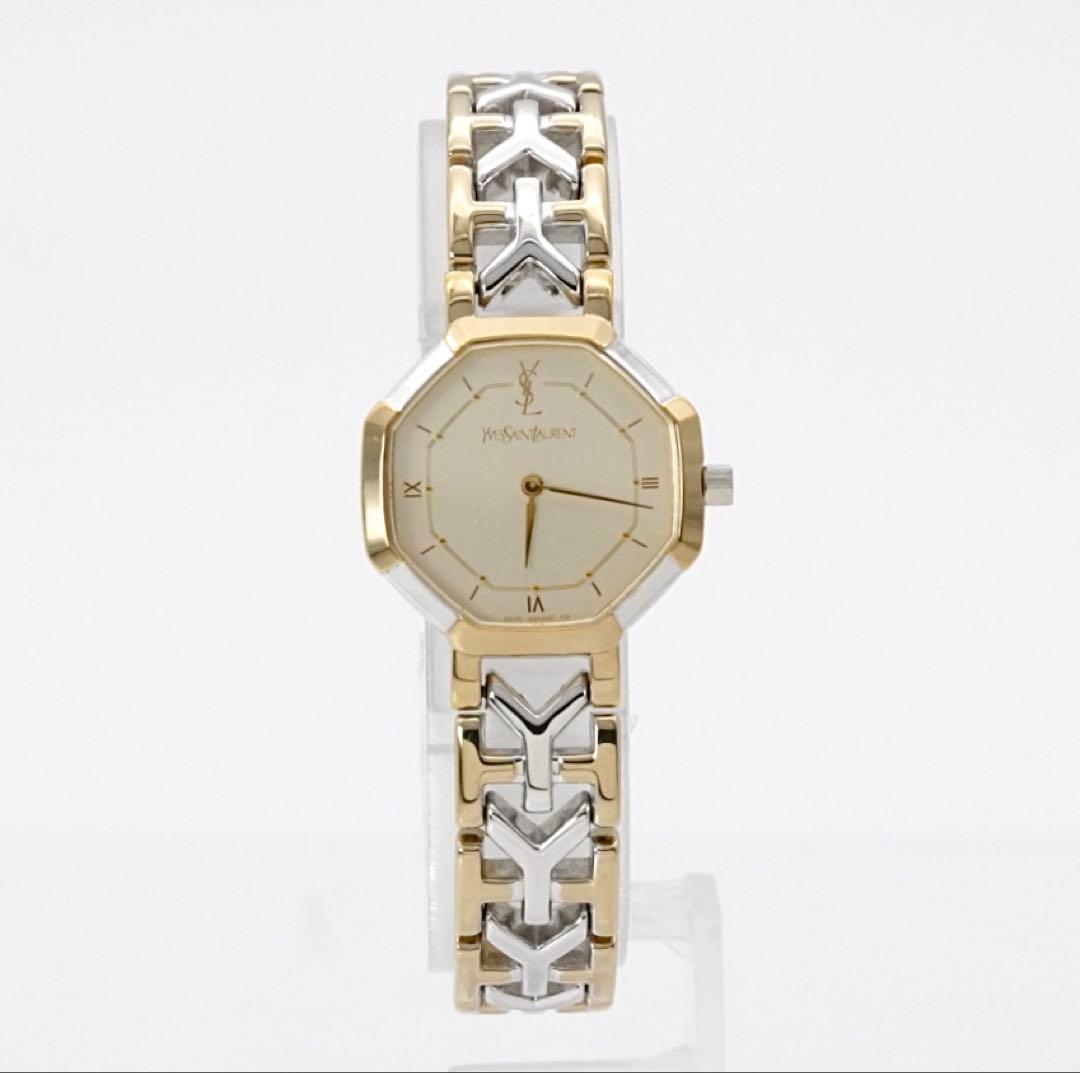 Front view of a Yves Saint Laurent two-tone (gold and silver) octagonal wristwatch with a cream dial and linked bracelet.