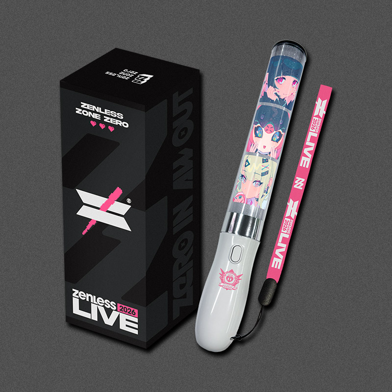 Photograph of the Z LIVE 2026 pen light showing the clear decorative tube with character artwork, white handle, pink wrist strap, and the black product box.
