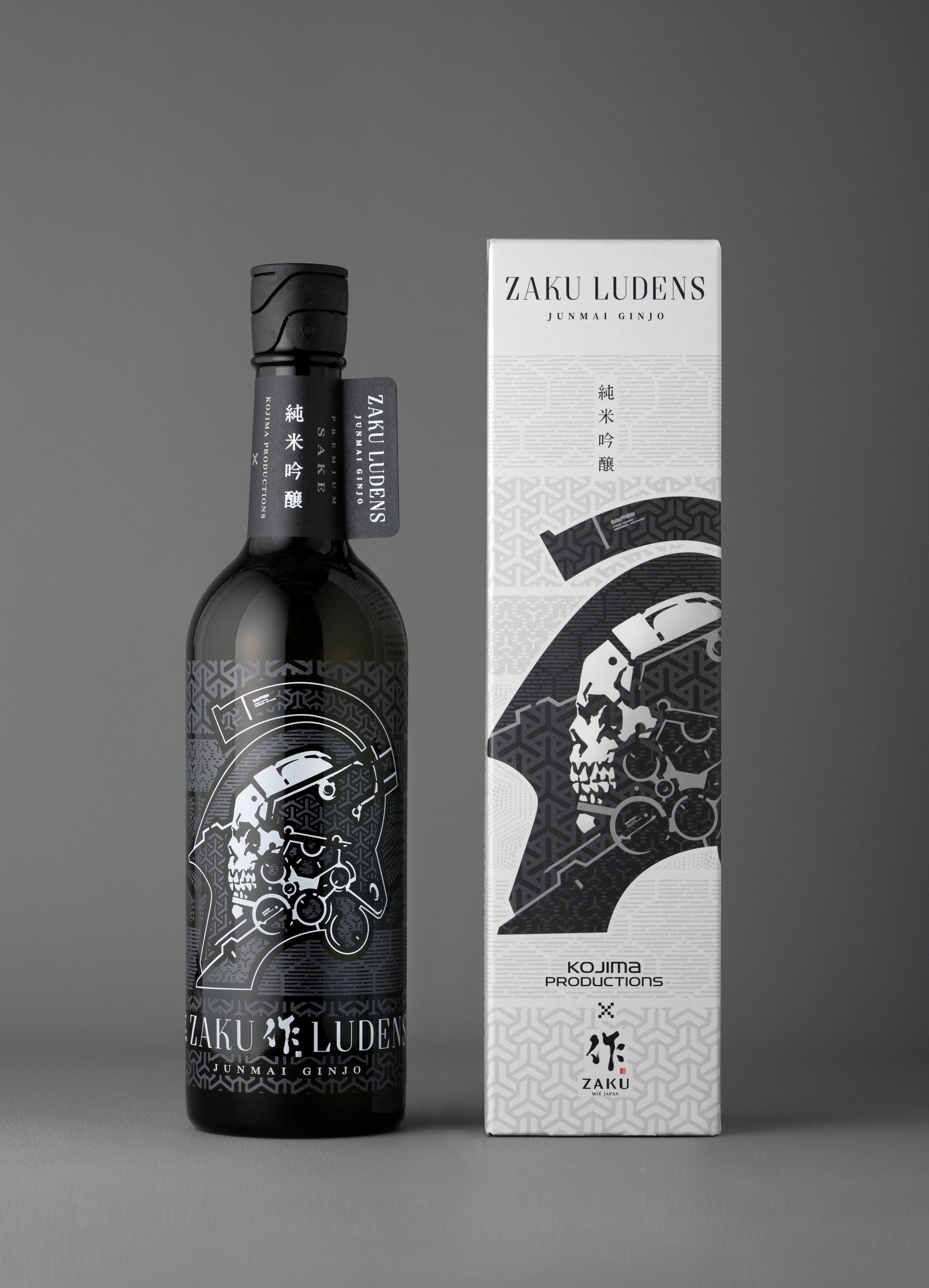 A bottle of sake (ZAKU LUDENS) standing next to its matching box on a gray background.