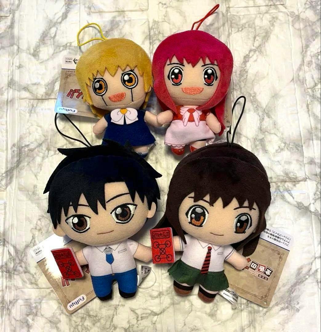 Four plush keychain dolls from the 金色のガッシュ‼︎ぬいぐるみ① コンプリートセット displayed on a light marble-pattern surface.