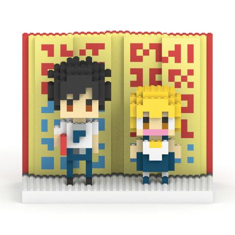 Front view of a block-style plastic figure set of ガッシュ・ベル (Gash Bell) and 高嶺清麿 (Kiyomaro Takamine) standing on a base with a yellow book-like backdrop.