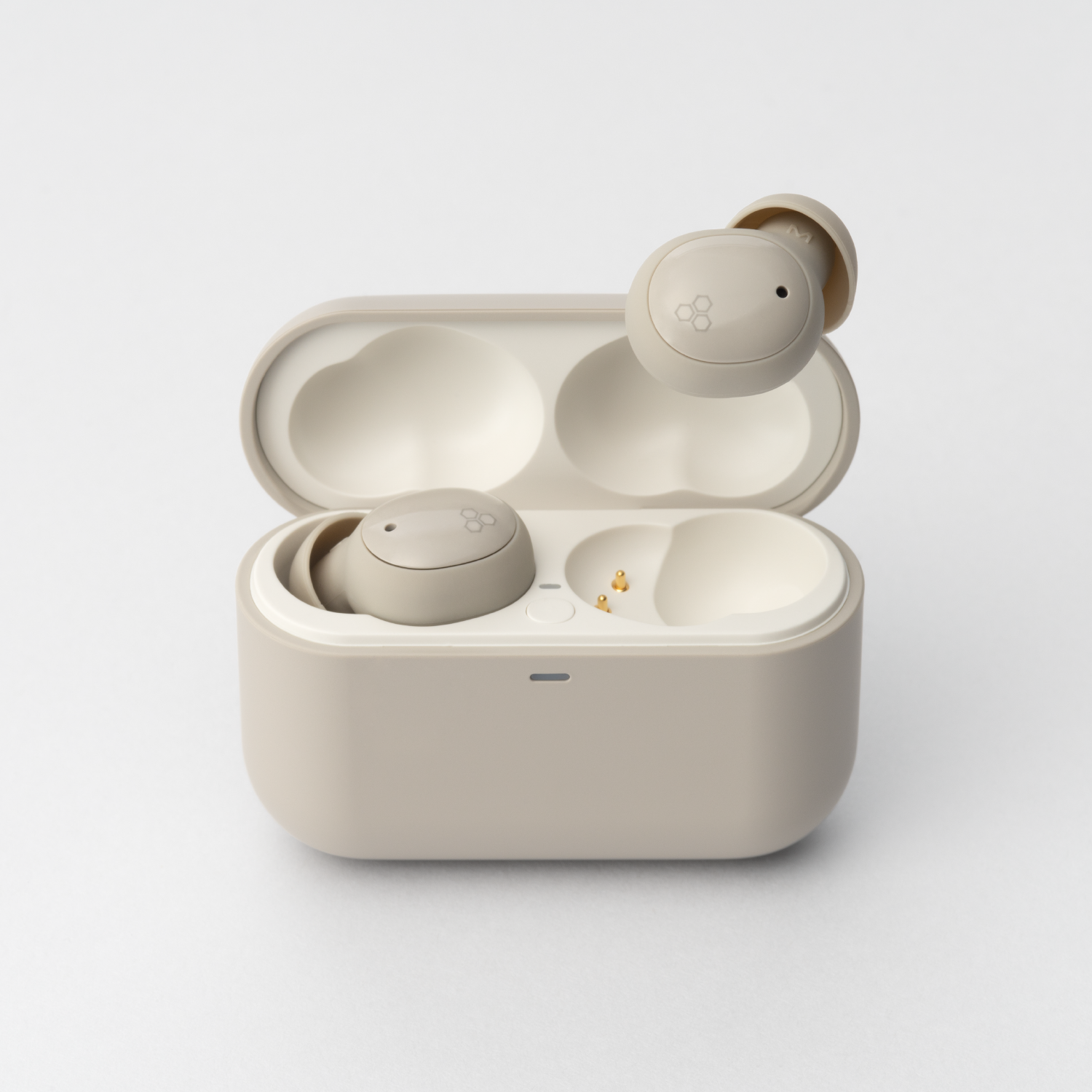 Beige ZE500 earphones with open case, one earbud held above its slot.