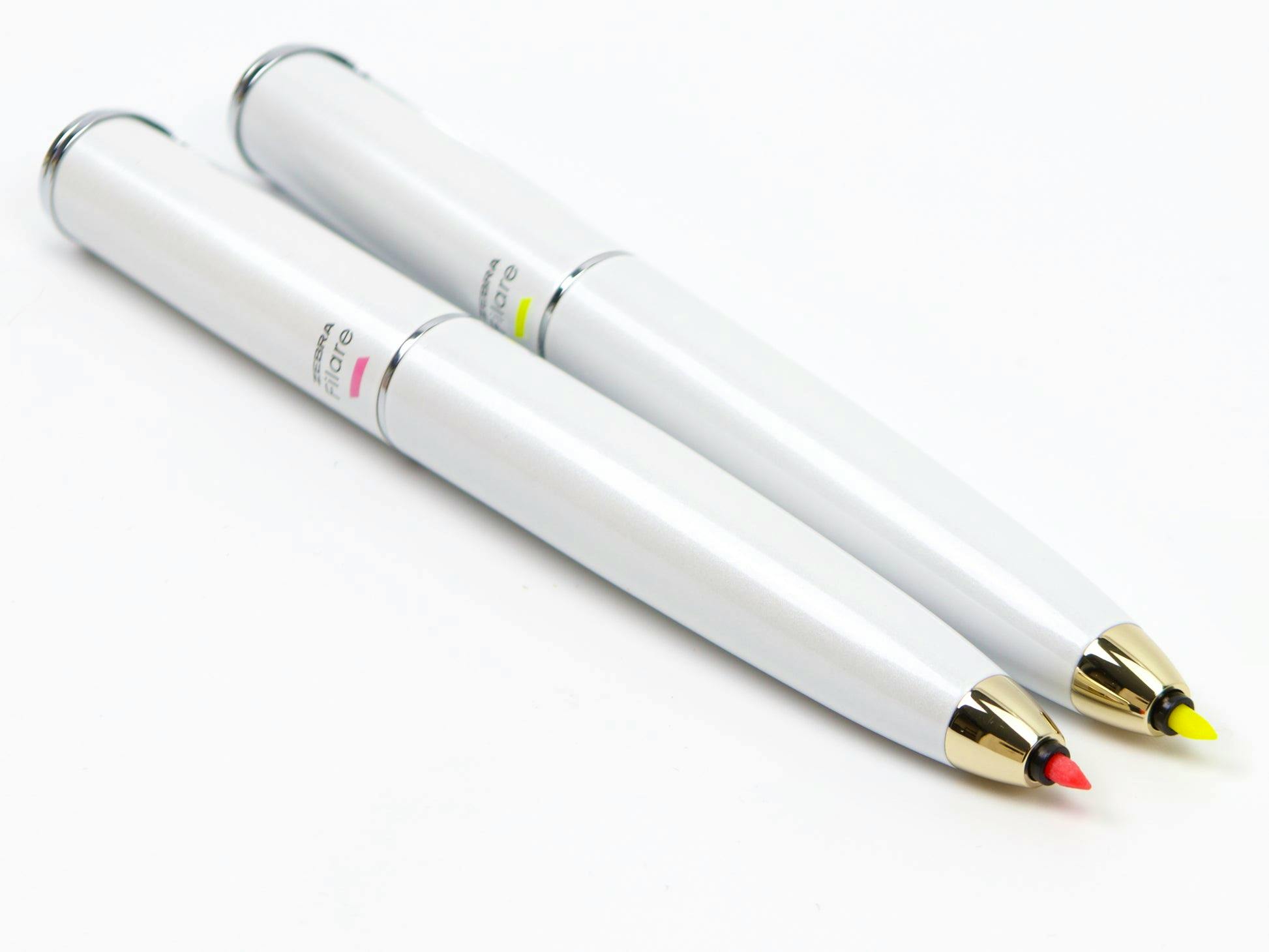 Close-up of two Zebra Filare Direction felt-tipped pens showing red and yellow nibs.