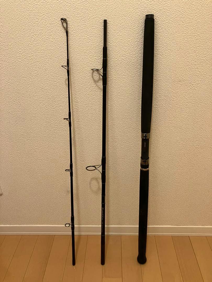 Three disassembled sections of the ZENAQ Expedition EP83-6 Trevally fishing rod leaning against a wall, showing the handle and rod guides.