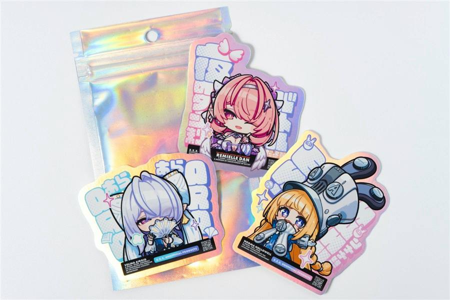 Three aurora-effect stickers from the ゼンレスゾーンゼロ sticker set arranged on a white background with a holographic pouch.