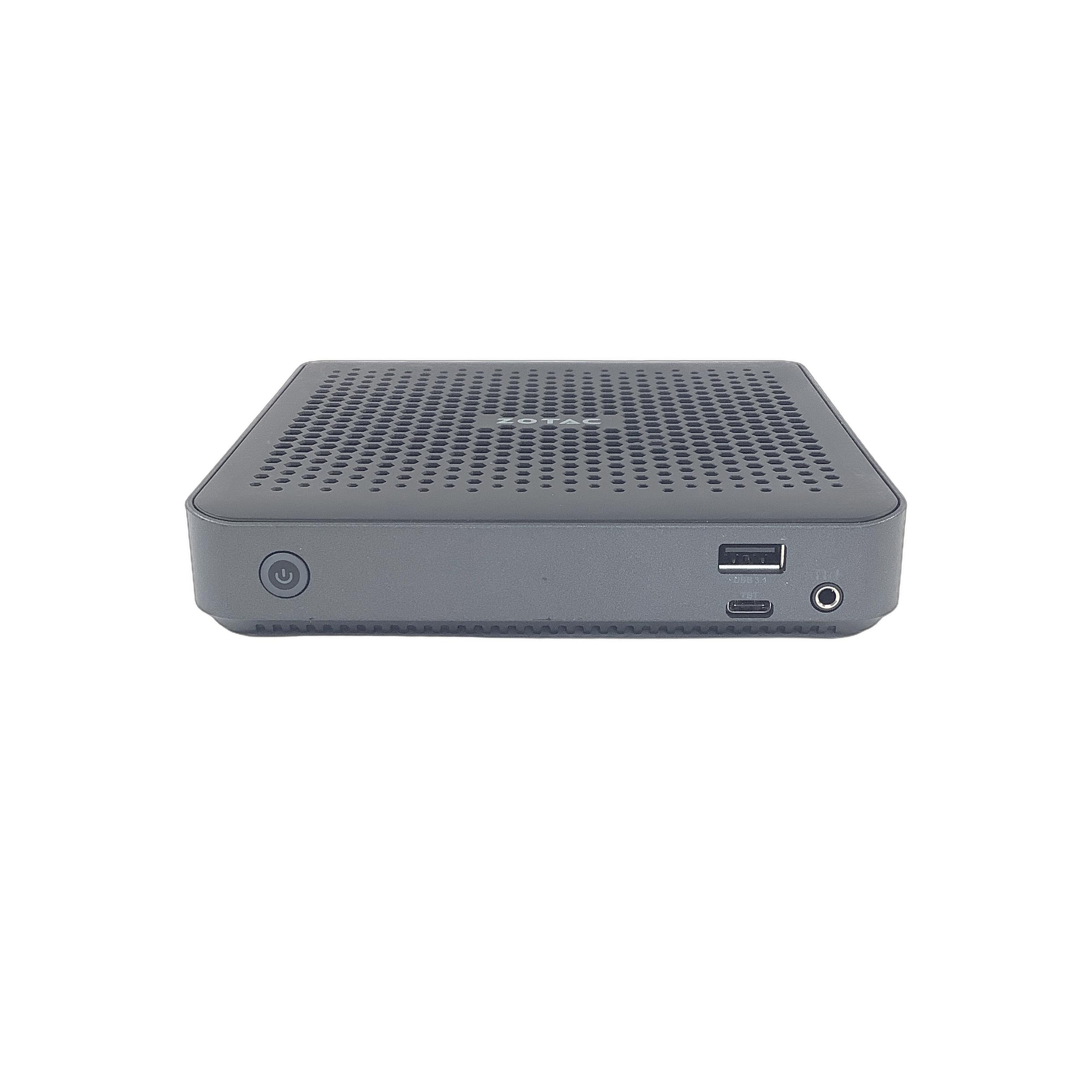 Front view of the mini PC showing the power button, USB ports, and perforated top vents.