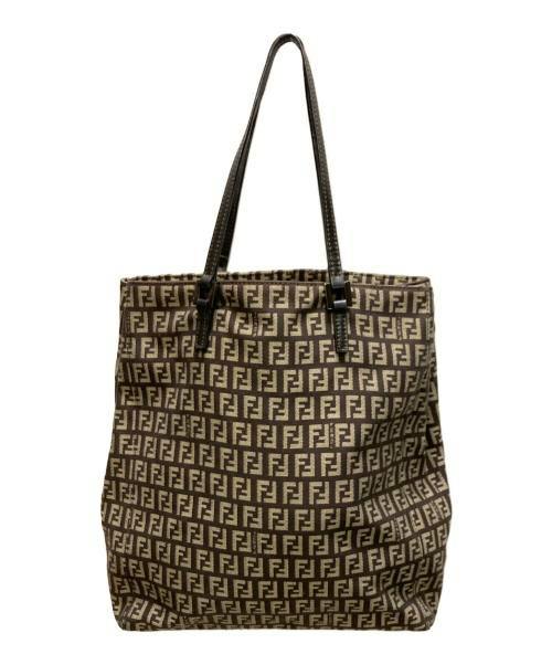 Canvas tote bag with a brown all-over monogram pattern and two dark shoulder straps.