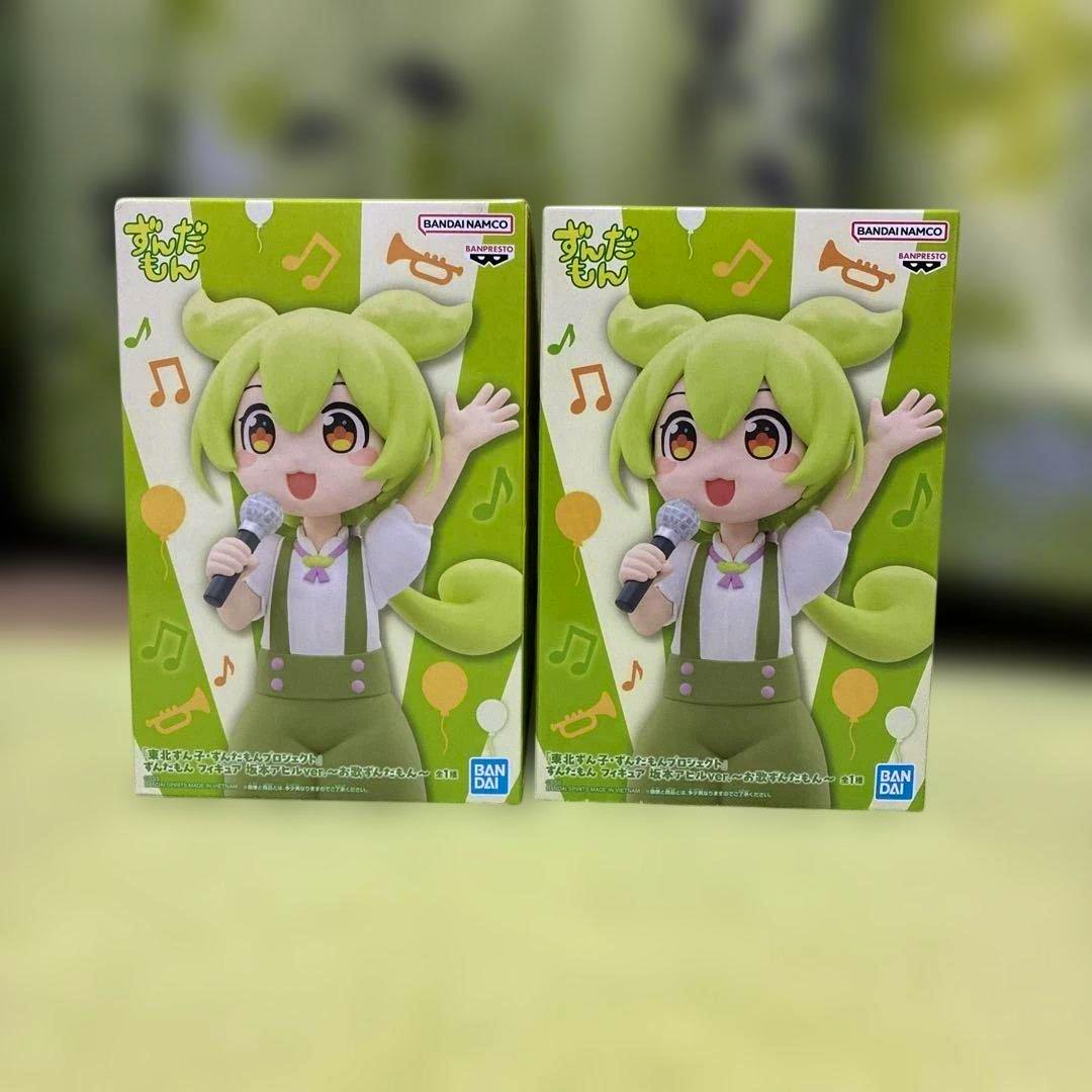 Two boxed ずんだもん フィギュア 坂本アヒルver. figure packages shown side by side.